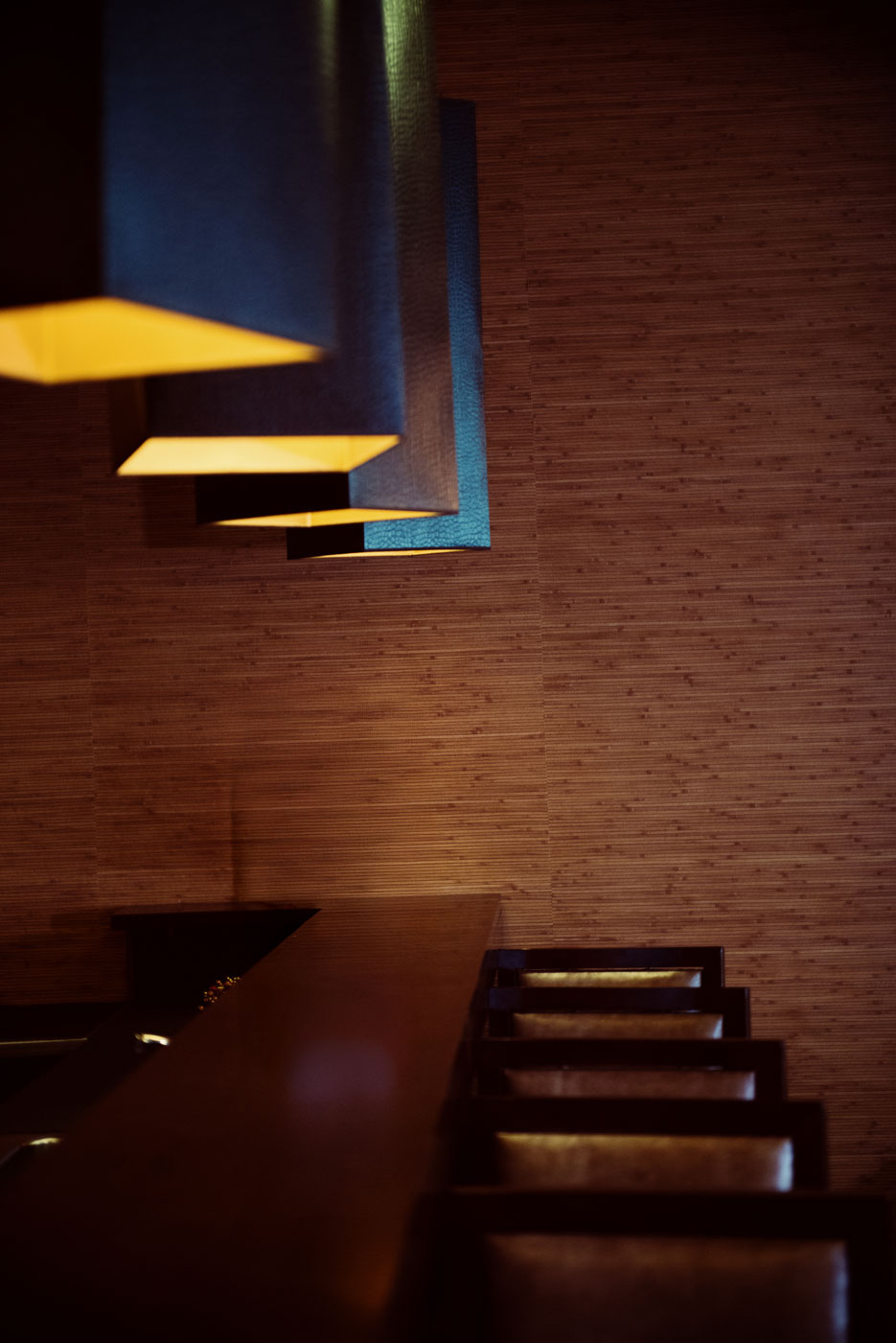 lights over a bar with stools