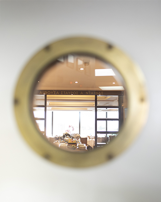 door with circular window looking at the dinning area